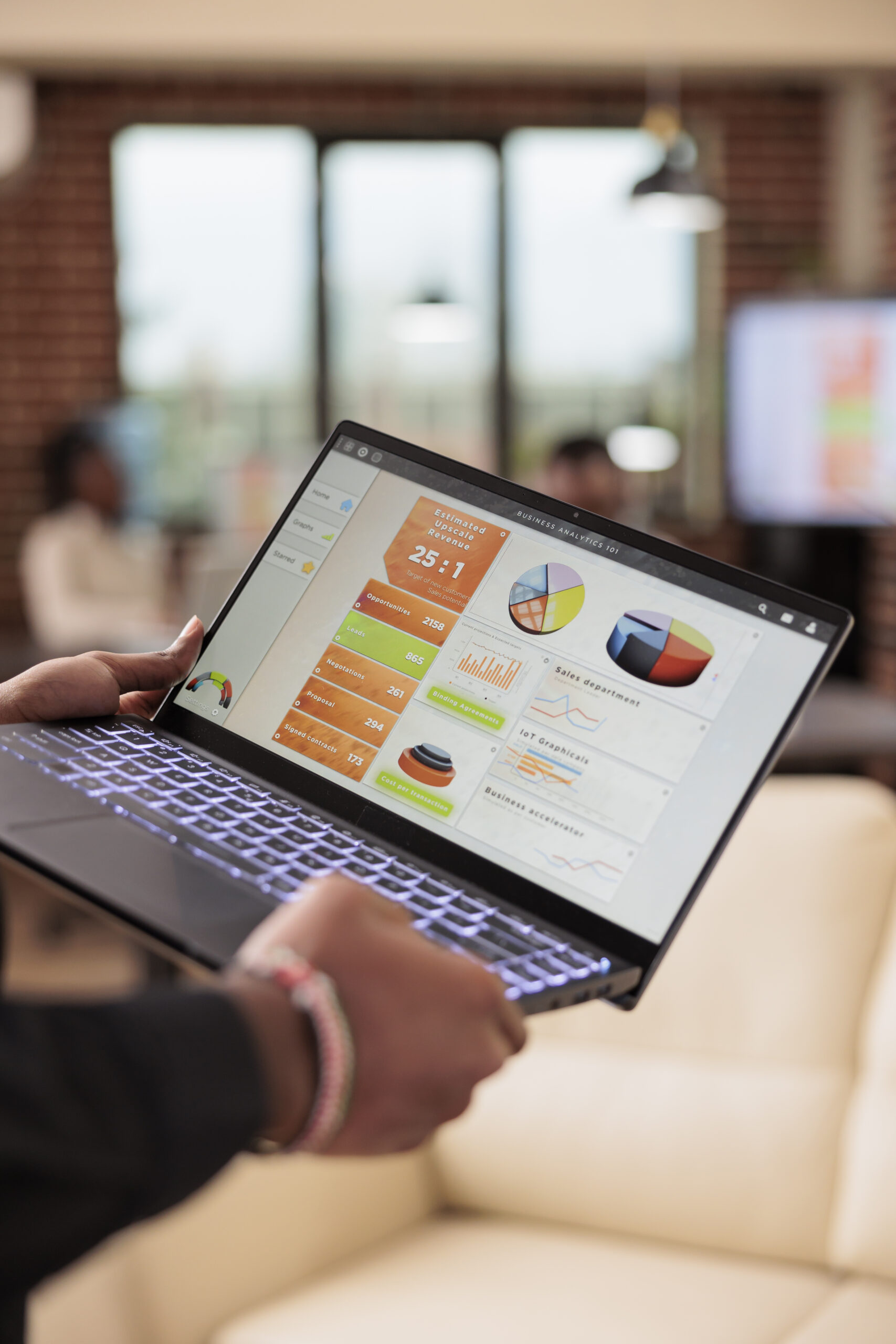 Acerca de nosotros Man Holding Laptop With Business Charts 2026 01 08 02 10 15 Utc 1 Scaled